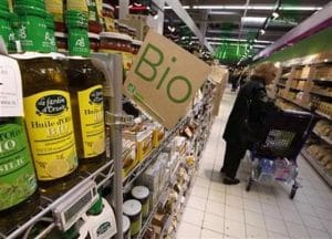 A customers buys organic products in the Bio foods section at Carrefour Planet supermarket in Nice Lingostiere
