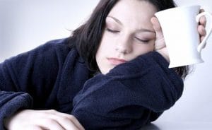 young woman awaking up early in the morning