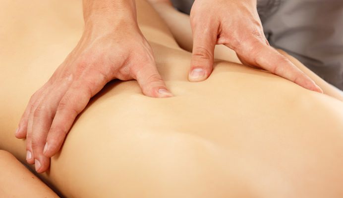 hands of masseur massaging woman young beautiful